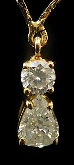 A modern gold and two stone diamond pendant